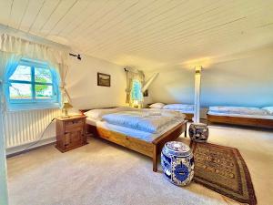 a bedroom with two beds and a window at Wellness Roubenka u Obory in Svratouch