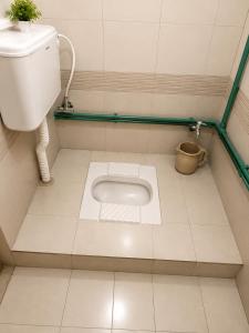 a small bathroom with a toilet and a sink at Highlander inn Skardu in Skardu +21 photos