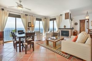 a living room with a view of the ocean at Villa Quietud in Salobreña
