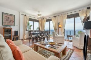 a living room with a view of the ocean at Villa Quietud in Salobreña