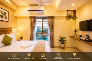 a hotel room with a bed and a window at Urban Comforts - Near US Consulate Business Hotel in T Nagar in Chennai