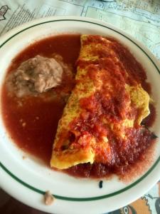 a plate of food with a slice of pizza at Alma Roma, Hogar con Alma, B&B in Mexico City