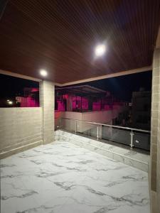 a room with a large marble floor with purple lights at Hotel Siyaram Inn in Trimbak +13 photos