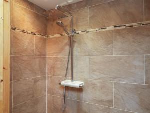 a shower with a shower head in a bathroom at Horseshoe Cottage in Middlesbrough +34 photos
