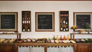 a counter with food and bottles of wine on a wall at iStay by NH Berlin City Ost Hotel in Berlin