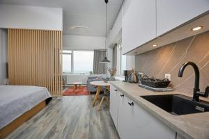 a kitchen with a sink and a bed in a room at World Trade Center Ballerup - Forenom in Ballerup +7 photos