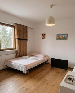 a bedroom with a bed and a window at DecaVillage Studios in Kuivanto