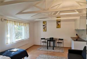 a living room with a table and a kitchen at DecaVillage Studios in Kuivanto