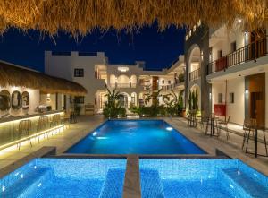 a pool in the middle of a resort at night at Santino Boutique Hotel in El Alamein