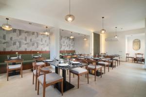 a large dining room with tables and chairs at Santino Boutique Hotel in El Alamein