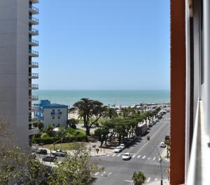 a view from a balcony of a street and the ocean at Hotel Bertiami in Mar del Plata