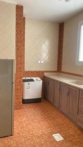 a kitchen with a counter and a refrigerator in a room at مشارف الفخامة أبها - Masharef AlFakhama ABHA in Abha +20 photos
