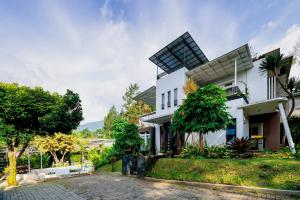 a house with a solarium on top of it at The Lavana Signature Villa Alessa Puncak in Puncak