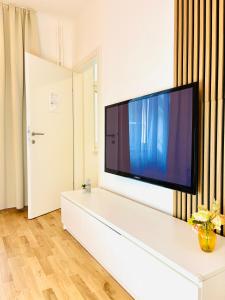 a living room with a large flat screen tv at Katys Cozy Corner - Self CheckIn in Graz +29 photos