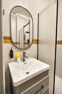 a bathroom with a sink and a mirror at NOOMA Hotel Aitmatova in Bishkek +30 photos