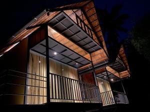 a large building with a balcony at night at Casa Kabani Resort in Chegāt