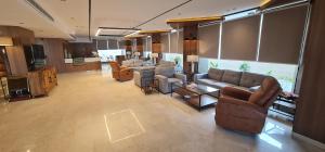a living room with couches and chairs in a building at شقق ضيافة خاصه خدمة ذاتية in Buraydah