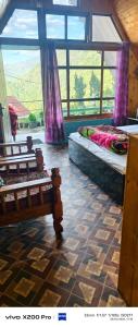 two beds sitting in a room with windows at Golays homestay in Kalimpong