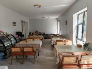 a restaurant with tables and chairs in a room at wushe hotel in Nanhu