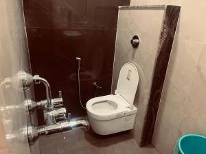 a bathroom with a white toilet in a stall at Maa Prabha Courtyard in Varanasi +36 photos