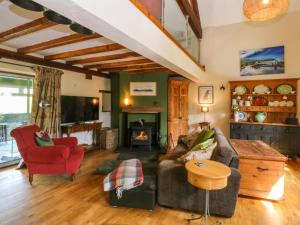 a living room with a couch and a fireplace at Pen Glorian in Conwy
