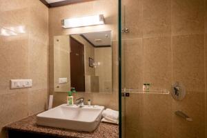 a bathroom with a sink and a mirror at Revathi Resorts in Jajal +45 photos