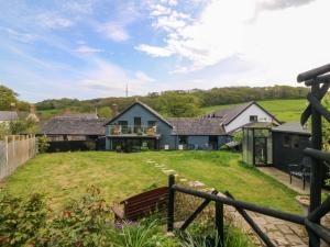 an exterior view of a house with a yard at Pen Glorian in Conwy
