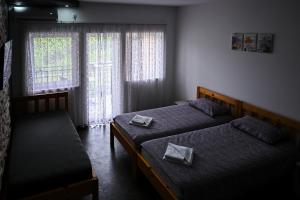 a bedroom with two beds and a window at RA Apartmani Vrdnik in Vrdnik