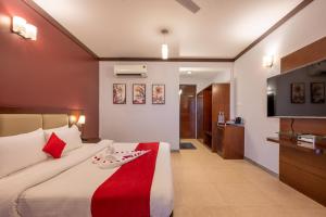 a hotel room with a bed and a television at Revathi Resorts in Jajal