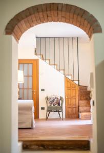 a room with a staircase and a bed and a chair at Spacious home near Orta, 8min in Armeno