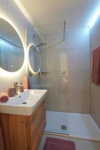 a bathroom with a sink and a shower at Dahoam beim Haas in Rieden +15 photos
