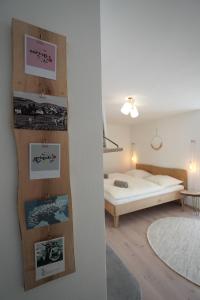a bedroom with a bed and posters on a wall at Dahoam beim Haas in Rieden