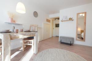 a kitchen and living room with a wooden table at Dahoam beim Haas in Rieden