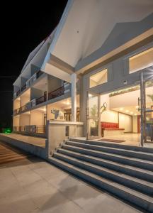 a house with stairs leading up to it at night at Revathi Resorts in Jajal