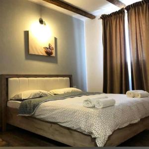 a bedroom with a bed with two towels on it at Vila Francisca10 in Alba Iulia