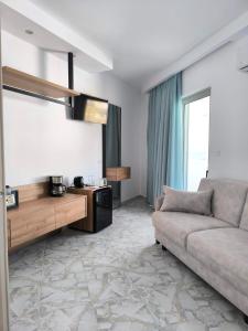 a living room with a couch and a table at Haraki Bay Hotel and Luxury Apartments in Haraki