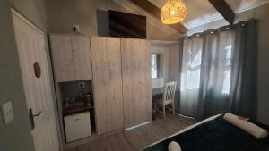 a small room with a wooden cabinet with a desk at SuNel's Guest Rooms in Malmesbury