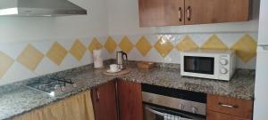 a kitchen with a counter top with a microwave at El Molino de Iramala in Reolid +30 photos