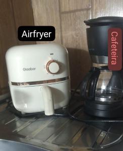 a white coffee maker sitting on top of a counter at Suite Love in Paty do Alferes