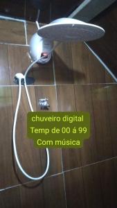 a shower coil on the floor in a bathroom at Suite Love in Paty do Alferes +3 photos