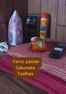a table topped with a pink towel with some items at Suite Love in Paty do Alferes