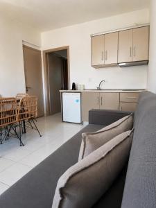 a living room with a couch and a kitchen at Filoxenia in Platy +15 photos