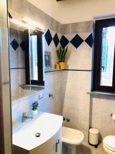 a bathroom with a sink and a toilet at Cipressi Rossi in Greve in Chianti +11 photos