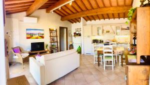a living room with a kitchen and a dining room at Cipressi Rossi in Greve in Chianti