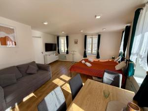 a living room with a couch and a bed at Apartmán Pepuška in Kašperské Hory