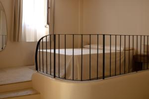 a crib in a room with a bed at Casa Olivi in Ventotene