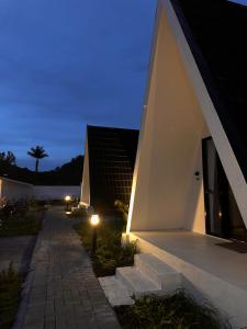 a house with a staircase leading up to it at night at Arjuna Hill in Sumberbrantas