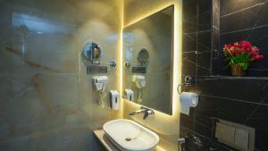 a bathroom with a sink and a mirror at Hotel Heritage Grand in Thane +35 photos