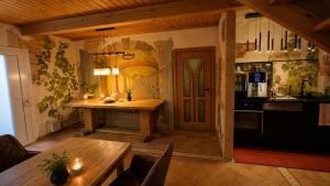 a kitchen with a wooden table and a dining room at Pension Nippgen in Radebeul