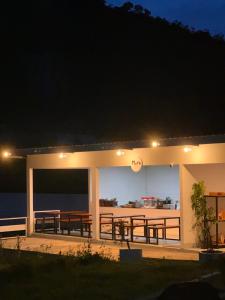 a building with a deck at night at Arjuna Hill in Sumberbrantas